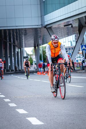 MOSCOW, RUSSIA - AUGUST 25, 2019: Ironman Cycling competition, cyclist athletes riding a race. Ironstar Crocus Fitness Triathlon.のeditorial素材