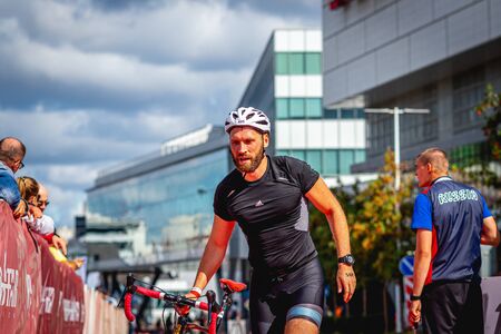 MOSCOW, RUSSIA - AUGUST 25, 2019: Ironman Cycling competition, cyclist athletes riding a race. Ironstar Crocus Fitness Triathlon.のeditorial素材