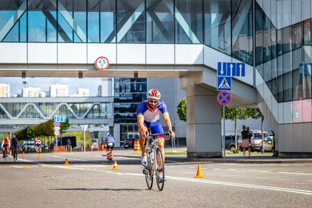 MOSCOW, RUSSIA - AUGUST 25, 2019: Ironman Cycling competition, cyclist athletes riding a race. Ironstar Crocus Fitness Triathlon.のeditorial素材