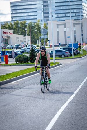 MOSCOW, RUSSIA - AUGUST 25, 2019: Ironman Cycling competition, cyclist athletes riding a race. Ironstar Crocus Fitness Triathlon.のeditorial素材