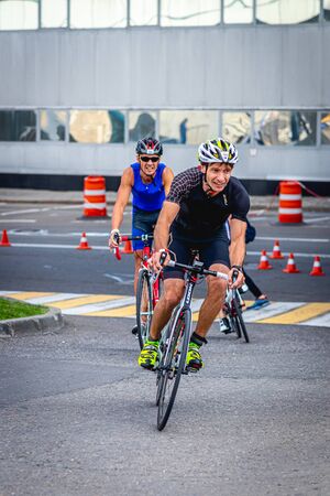 MOSCOW, RUSSIA - AUGUST 25, 2019: Ironman Cycling competition, cyclist athletes riding a race. Ironstar Crocus Fitness Triathlon.のeditorial素材