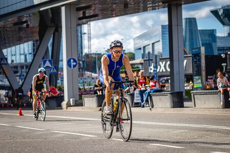 MOSCOW, RUSSIA - AUGUST 25, 2019: Ironman Cycling competition, cyclist athletes riding a race. Ironstar Crocus Fitness Triathlon.のeditorial素材