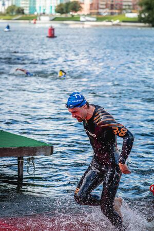 MOSCOW, RUSSIA - AUGUST 25, 2019: Ironman Swimmers on the open waters event Moscow river. Ironstar Crocus Fitness Triathlon 2019.のeditorial素材