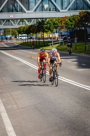 MOSCOW, RUSSIA - AUGUST 25, 2019: Ironman Cycling competition, cyclist athletes riding a race. Ironstar Crocus Fitness Triathlon.のeditorial素材