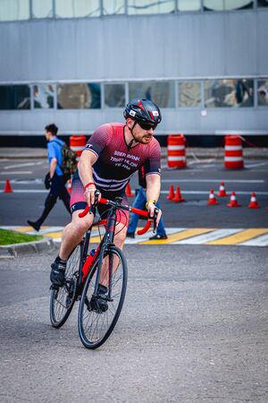 MOSCOW, RUSSIA - AUGUST 25, 2019: Ironman Cycling competition, cyclist athletes riding a race. Ironstar Crocus Fitness Triathlon.のeditorial素材