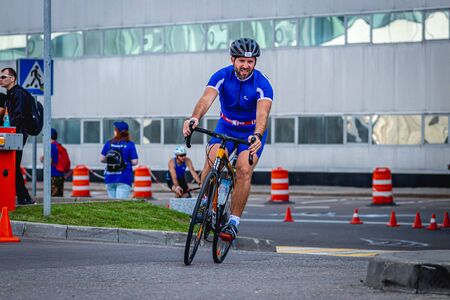 MOSCOW, RUSSIA - AUGUST 25, 2019: Ironman Cycling competition, cyclist athletes riding a race. Ironstar Crocus Fitness Triathlon.のeditorial素材