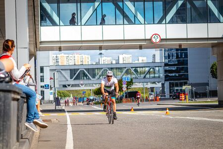 MOSCOW, RUSSIA - AUGUST 25, 2019: Ironman Cycling competition, cyclist athletes riding a race. Ironstar Crocus Fitness Triathlon.のeditorial素材