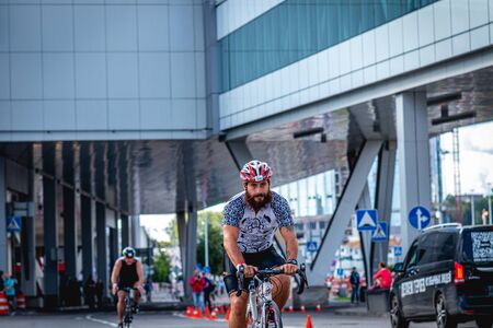 MOSCOW, RUSSIA - AUGUST 25, 2019: Ironman Cycling competition, cyclist athletes riding a race. Ironstar Crocus Fitness Triathlon.のeditorial素材