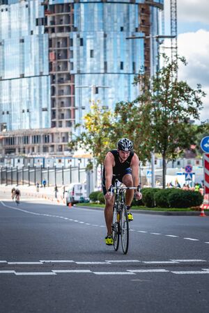 MOSCOW, RUSSIA - AUGUST 25, 2019: Ironman Cycling competition, cyclist athletes riding a race. Ironstar Crocus Fitness Triathlon.のeditorial素材