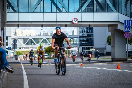 MOSCOW, RUSSIA - AUGUST 25, 2019: Ironman Cycling competition, cyclist athletes riding a race. Ironstar Crocus Fitness Triathlon.のeditorial素材