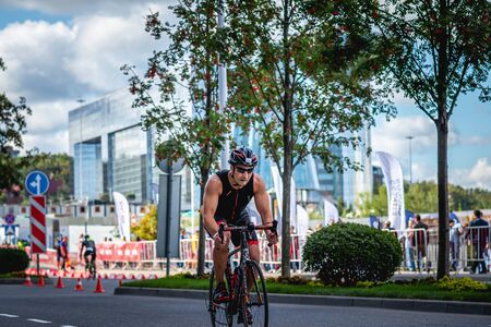 MOSCOW, RUSSIA - AUGUST 25, 2019: Ironman Cycling competition, cyclist athletes riding a race. Ironstar Crocus Fitness Triathlon.のeditorial素材