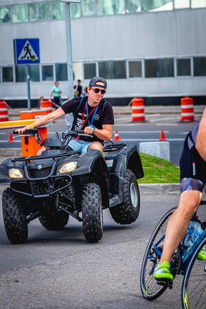 MOSCOW, RUSSIA - AUGUST 25, 2019: Ironman Cycling competition, cyclist athletes riding a race. Ironstar Crocus Fitness Triathlon.のeditorial素材