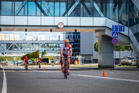 MOSCOW, RUSSIA - AUGUST 25, 2019: Ironman Cycling competition, cyclist athletes riding a race. Ironstar Crocus Fitness Triathlon.のeditorial素材