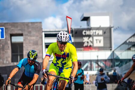 MOSCOW, RUSSIA - AUGUST 25, 2019: Ironman Cycling competition, cyclist athletes riding a race. Ironstar Crocus Fitness Triathlon.のeditorial素材