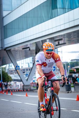 MOSCOW, RUSSIA - AUGUST 25, 2019: Ironman Cycling competition, cyclist athletes riding a race. Ironstar Crocus Fitness Triathlon.のeditorial素材
