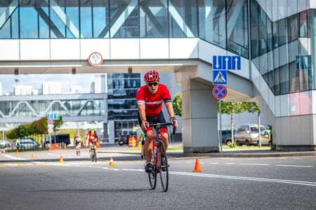 MOSCOW, RUSSIA - AUGUST 25, 2019: Ironman Cycling competition, cyclist athletes riding a race. Ironstar Crocus Fitness Triathlon.のeditorial素材