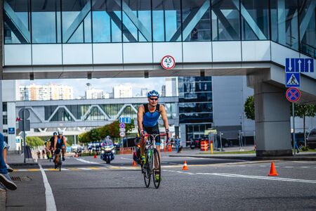 MOSCOW, RUSSIA - AUGUST 25, 2019: Ironman Cycling competition, cyclist athletes riding a race. Ironstar Crocus Fitness Triathlon.のeditorial素材