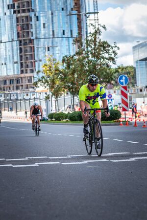 MOSCOW, RUSSIA - AUGUST 25, 2019: Ironman Cycling competition, cyclist athletes riding a race. Ironstar Crocus Fitness Triathlon.のeditorial素材