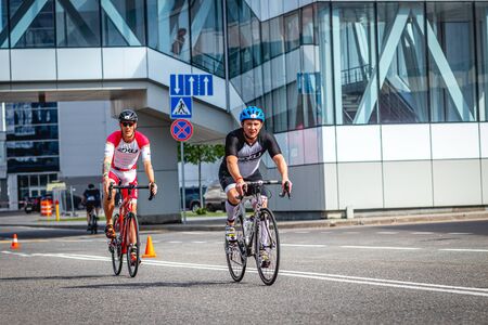MOSCOW, RUSSIA - AUGUST 25, 2019: Ironman Cycling competition, cyclist athletes riding a race. Ironstar Crocus Fitness Triathlon.のeditorial素材
