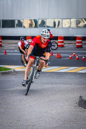 MOSCOW, RUSSIA - AUGUST 25, 2019: Ironman Cycling competition, cyclist athletes riding a race. Ironstar Crocus Fitness Triathlon.のeditorial素材