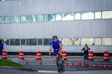 MOSCOW, RUSSIA - AUGUST 25, 2019: Ironman Cycling competition, cyclist athletes riding a race. Ironstar Crocus Fitness Triathlon.のeditorial素材