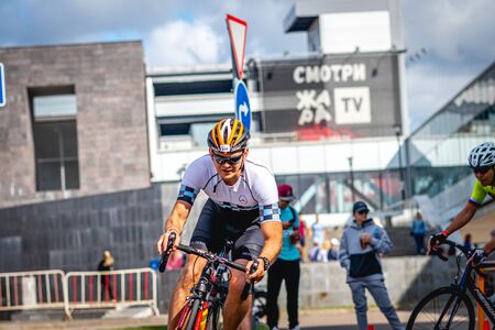MOSCOW, RUSSIA - AUGUST 25, 2019: Ironman Cycling competition, cyclist athletes riding a race. Ironstar Crocus Fitness Triathlon.のeditorial素材