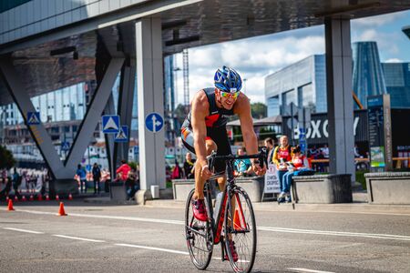 MOSCOW, RUSSIA - AUGUST 25, 2019: Ironman Cycling competition, cyclist athletes riding a race. Ironstar Crocus Fitness Triathlon.のeditorial素材