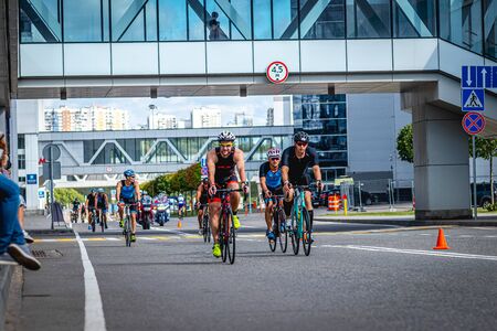 MOSCOW, RUSSIA - AUGUST 25, 2019: Ironman Cycling competition, cyclist athletes riding a race. Ironstar Crocus Fitness Triathlon.のeditorial素材