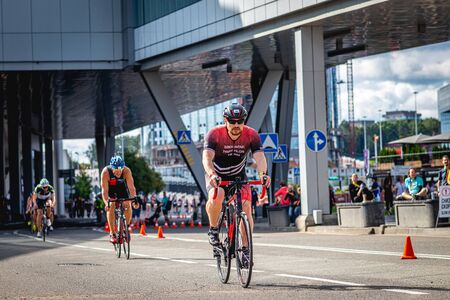 MOSCOW, RUSSIA - AUGUST 25, 2019: Ironman Cycling competition, cyclist athletes riding a race. Ironstar Crocus Fitness Triathlon.のeditorial素材