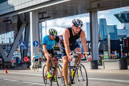 MOSCOW, RUSSIA - AUGUST 25, 2019: Ironman Cycling competition, cyclist athletes riding a race. Ironstar Crocus Fitness Triathlon.のeditorial素材