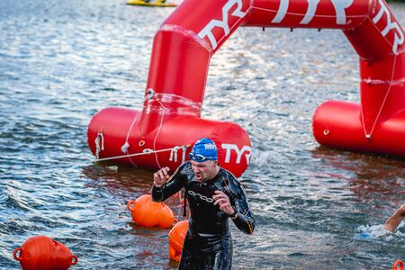 MOSCOW, RUSSIA - AUGUST 25, 2019: Ironman Swimmers on the open waters event Moscow river. Ironstar Crocus Fitness Triathlon 2019.のeditorial素材