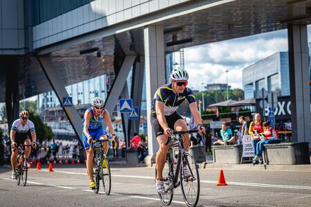 MOSCOW, RUSSIA - AUGUST 25, 2019: Ironman Cycling competition, cyclist athletes riding a race. Ironstar Crocus Fitness Triathlon.のeditorial素材