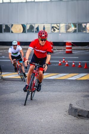 MOSCOW, RUSSIA - AUGUST 25, 2019: Ironman Cycling competition, cyclist athletes riding a race. Ironstar Crocus Fitness Triathlon.のeditorial素材