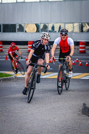 MOSCOW, RUSSIA - AUGUST 25, 2019: Ironman Cycling competition, cyclist athletes riding a race. Ironstar Crocus Fitness Triathlon.のeditorial素材