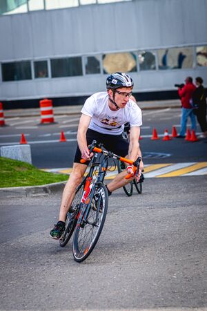 MOSCOW, RUSSIA - AUGUST 25, 2019: Ironman Cycling competition, cyclist athletes riding a race. Ironstar Crocus Fitness Triathlon.のeditorial素材