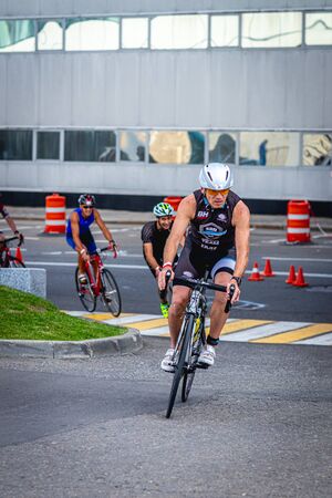 MOSCOW, RUSSIA - AUGUST 25, 2019: Ironman Cycling competition, cyclist athletes riding a race. Ironstar Crocus Fitness Triathlon.のeditorial素材
