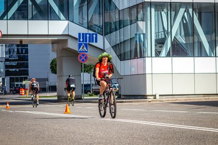 MOSCOW, RUSSIA - AUGUST 25, 2019: Ironman Cycling competition, cyclist athletes riding a race. Ironstar Crocus Fitness Triathlon.のeditorial素材
