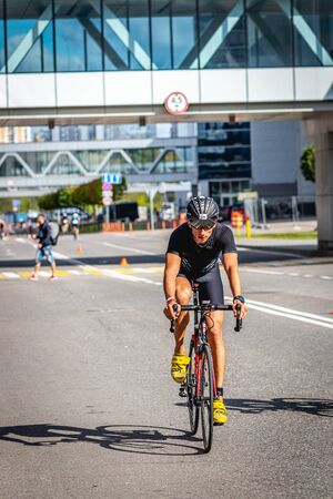 MOSCOW, RUSSIA - AUGUST 25, 2019: Ironman Cycling competition, cyclist athletes riding a race. Ironstar Crocus Fitness Triathlon.のeditorial素材