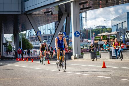 MOSCOW, RUSSIA - AUGUST 25, 2019: Ironman Cycling competition, cyclist athletes riding a race. Ironstar Crocus Fitness Triathlon.のeditorial素材