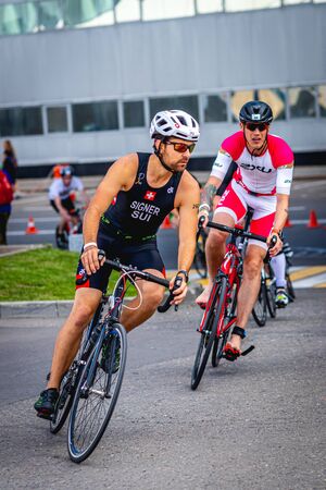 MOSCOW, RUSSIA - AUGUST 25, 2019: Ironman Cycling competition, cyclist athletes riding a race. Ironstar Crocus Fitness Triathlon.のeditorial素材