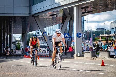 MOSCOW, RUSSIA - AUGUST 25, 2019: Ironman Cycling competition, cyclist athletes riding a race. Ironstar Crocus Fitness Triathlon.のeditorial素材