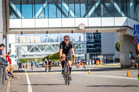 MOSCOW, RUSSIA - AUGUST 25, 2019: Ironman Cycling competition, cyclist athletes riding a race. Ironstar Crocus Fitness Triathlon.のeditorial素材
