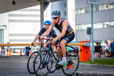 MOSCOW, RUSSIA - AUGUST 25, 2019: Ironman Cycling competition, cyclist athletes riding a race. Ironstar Crocus Fitness Triathlon.のeditorial素材
