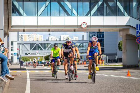 MOSCOW, RUSSIA - AUGUST 25, 2019: Ironman Cycling competition, cyclist athletes riding a race. Ironstar Crocus Fitness Triathlon.のeditorial素材