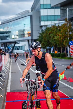 MOSCOW, RUSSIA - AUGUST 25, 2019: Ironman Cycling competition, cyclist athletes riding a race. Ironstar Crocus Fitness Triathlon.のeditorial素材