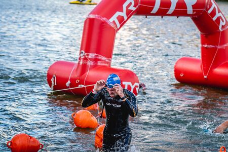 MOSCOW, RUSSIA - AUGUST 25, 2019: Ironman Swimmers on the open waters event Moscow river. Ironstar Crocus Fitness Triathlon 2019.のeditorial素材