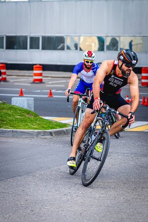 MOSCOW, RUSSIA - AUGUST 25, 2019: Ironman Cycling competition, cyclist athletes riding a race. Ironstar Crocus Fitness Triathlon.のeditorial素材