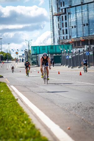 MOSCOW, RUSSIA - AUGUST 25, 2019: Ironman Cycling competition, cyclist athletes riding a race. Ironstar Crocus Fitness Triathlon.のeditorial素材