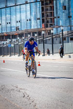MOSCOW, RUSSIA - AUGUST 25, 2019: Ironman Cycling competition, cyclist athletes riding a race. Ironstar Crocus Fitness Triathlon.のeditorial素材