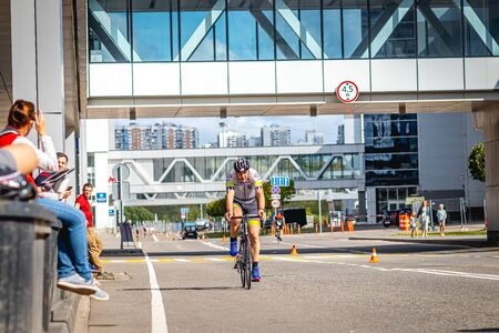 MOSCOW, RUSSIA - AUGUST 25, 2019: Ironman Cycling competition, cyclist athletes riding a race. Ironstar Crocus Fitness Triathlon.のeditorial素材